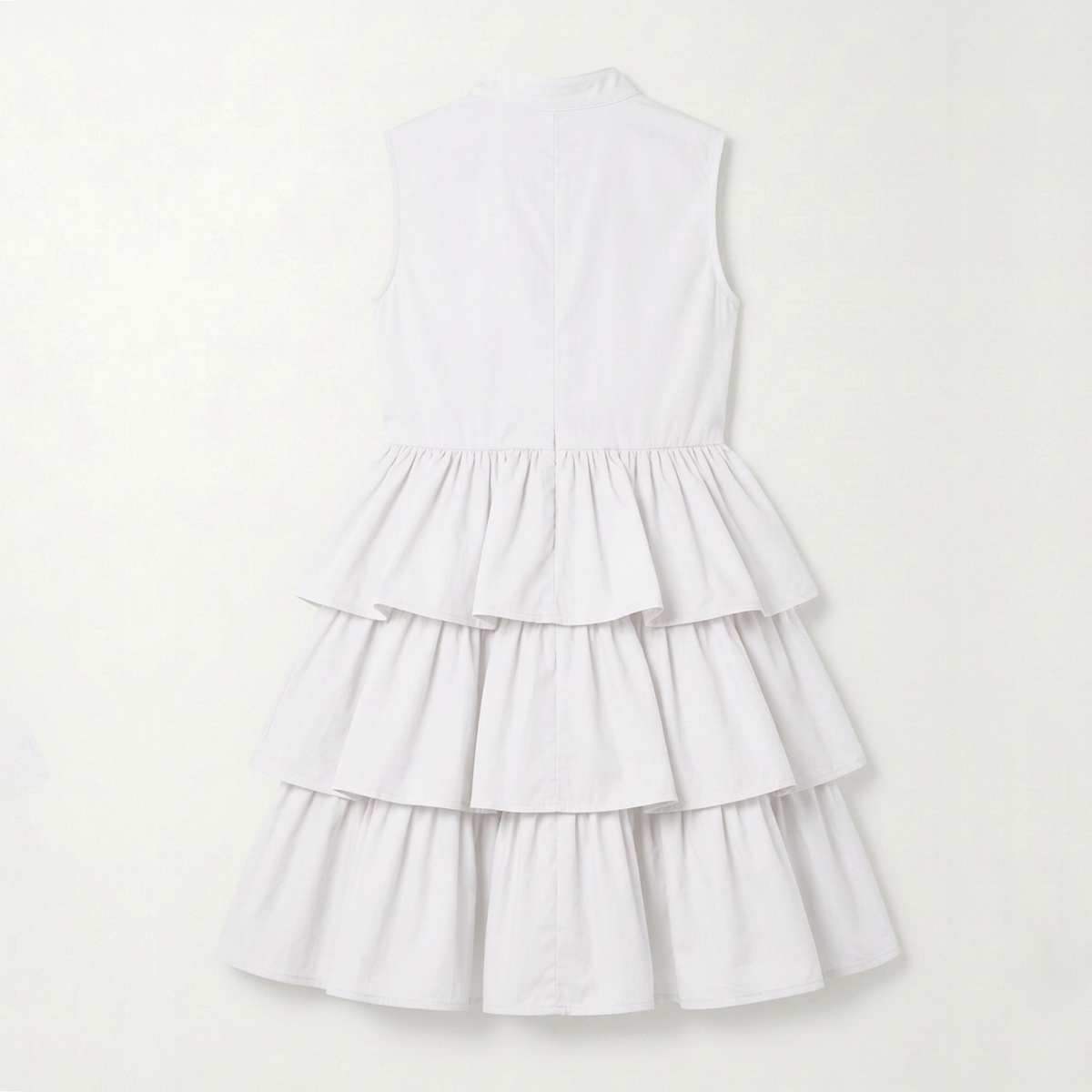 A sleeveless white tiered dress with a high mock neck, photographed from the back against a clean, off-white background.