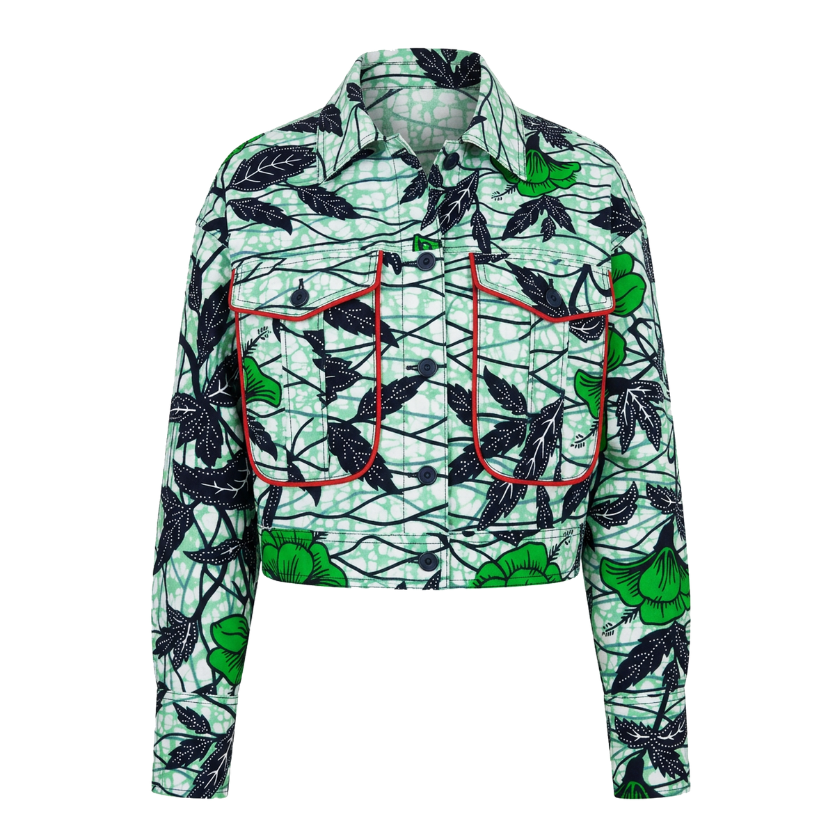 A women's long-sleeve cropped button-up shirt with a green, black, and white botanical leaf pattern, featuring two front chest pockets with red piping.