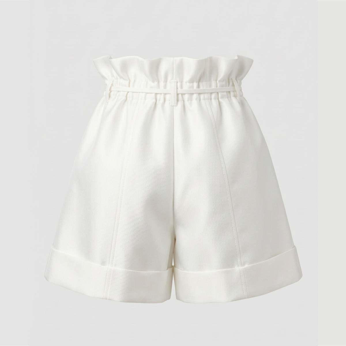 White high-waisted shorts with a paperbag waist and rolled hems, shown against a light gray background.