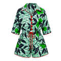 A women's short-sleeve romper with a green and black tropical floral print, featuring red piping, red buttons, and a red drawstring waist, shown on a plain white background.
