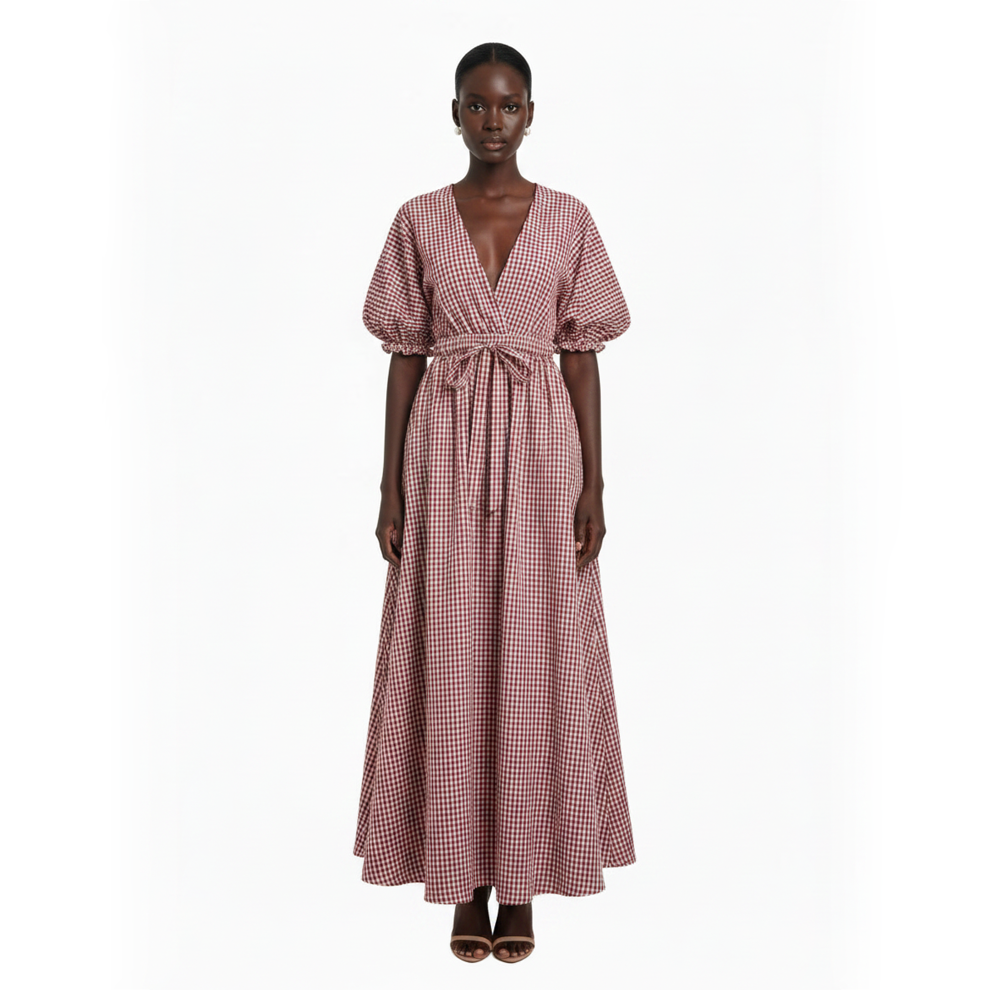 Woman wearing a pink checkered dress on a white background