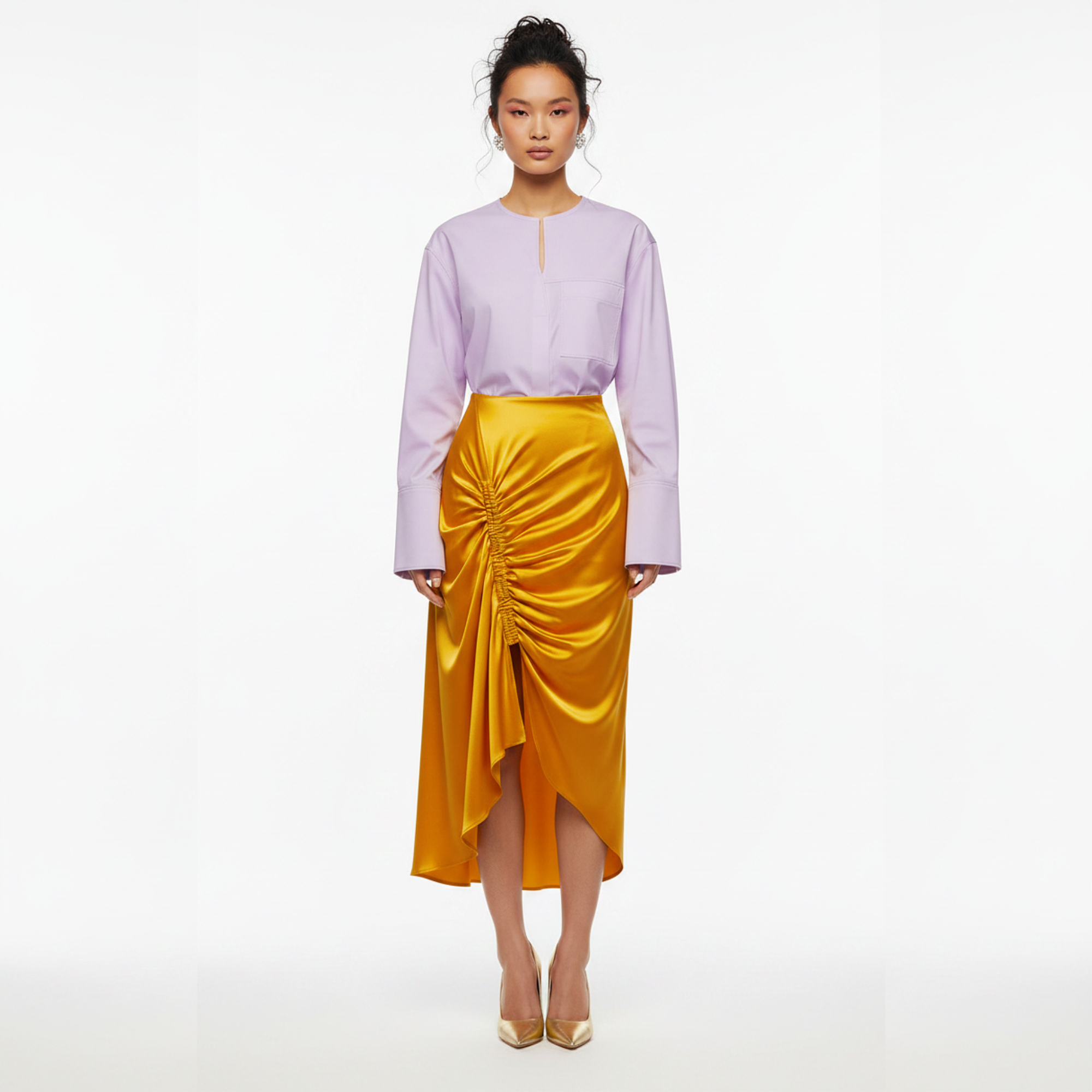 Woman wearing a light purple blouse and yellow skirt on a white background