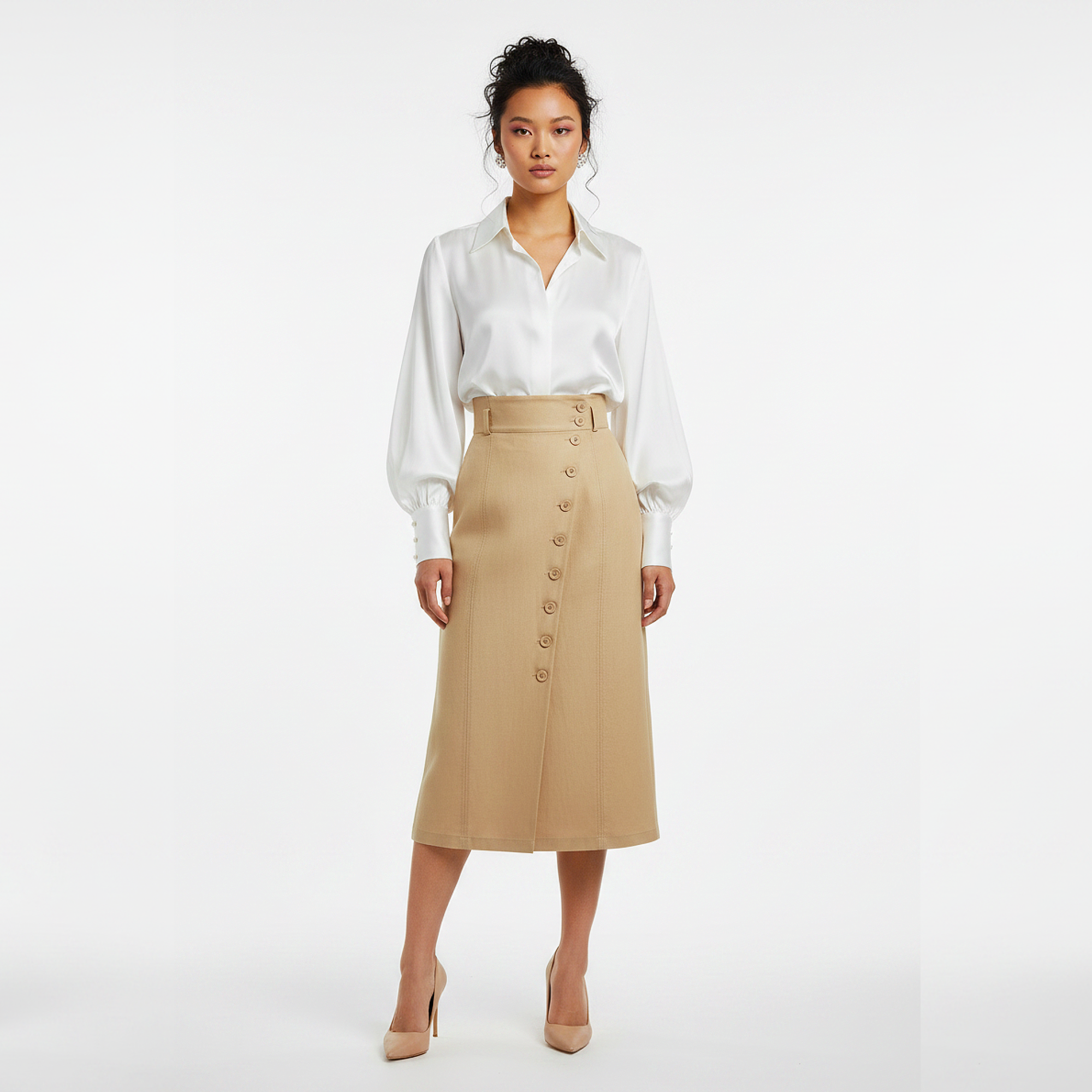 Woman wearing a white blouse and beige skirt on a white background