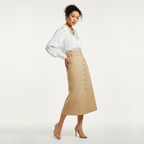 Woman wearing a white blouse and beige skirt on a white background