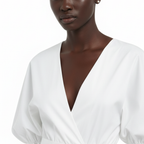 White blouse worn by a model on a white background
