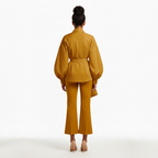 Woman wearing a mustard yellow outfit on a white background