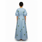 Light blue dress with green floral patterns on a white background