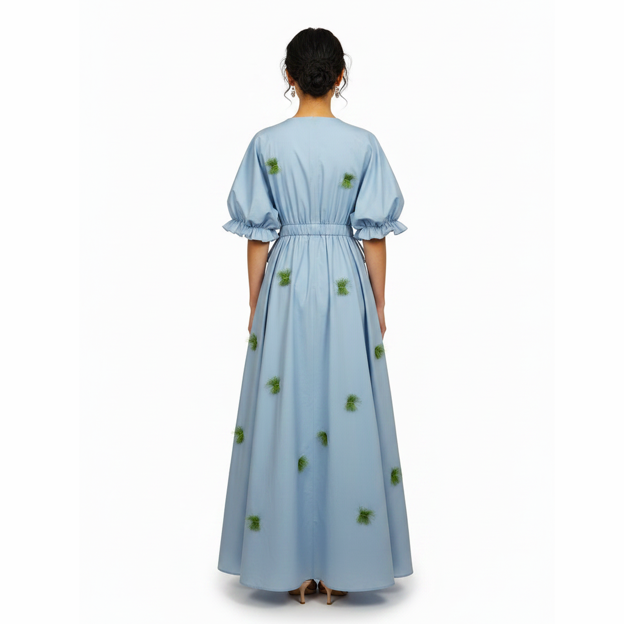 Light blue dress with green floral patterns on a white background
