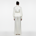Person wearing a white outfit on a white background