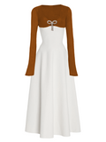 White dress with brown long-sleeve top on a white background