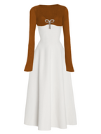 White dress with brown long-sleeve top on a white background