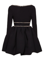 Black dress with pearl embellishments on a white background