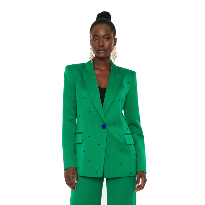 Woman wearing a green suit with blue accents on a white background