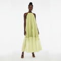 Woman wearing a light green dress on a white background