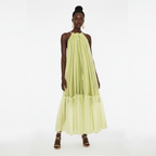 Woman wearing a light green dress on a white background