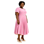Woman wearing a pink dress with a white background