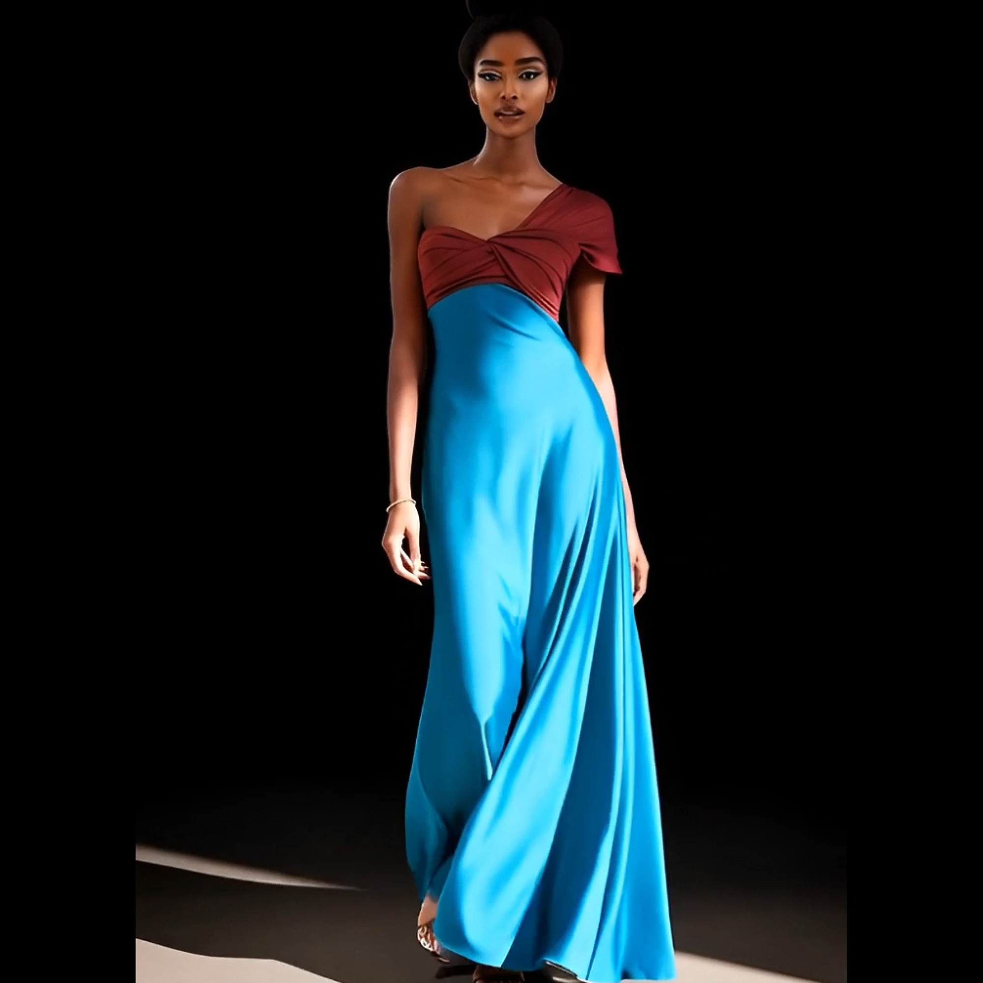 Woman wearing a one-shoulder red top and blue gown on a black background