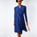 Woman wearing a blue dress holding a beige handbag on a white background
