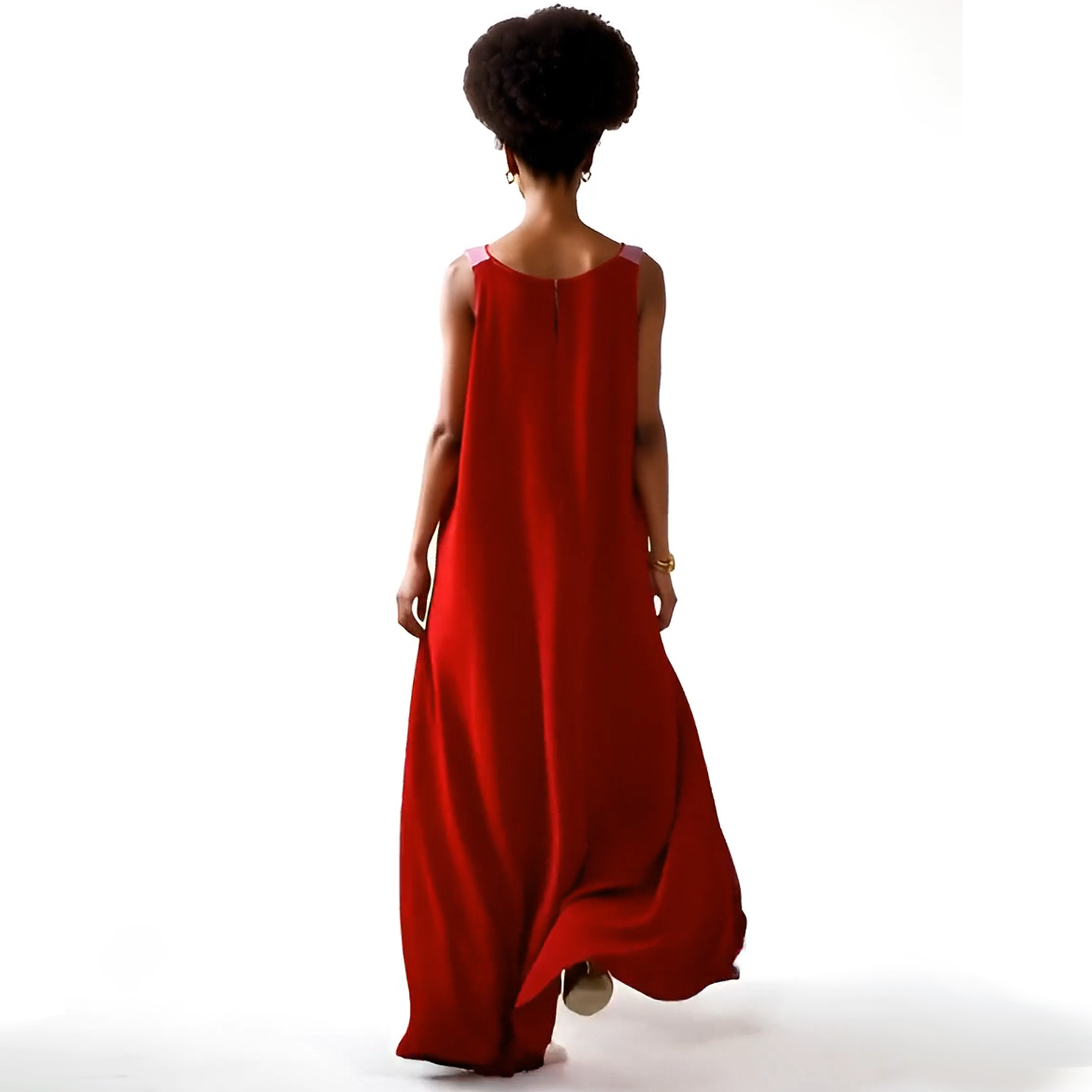 Person wearing a red dress with a plain white background
