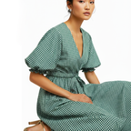 Woman wearing a green checkered dress on a white background