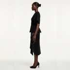 Woman wearing a black outfit on a white background