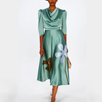 Green dress with floral design on a white background