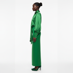Woman wearing a green dress on a white background