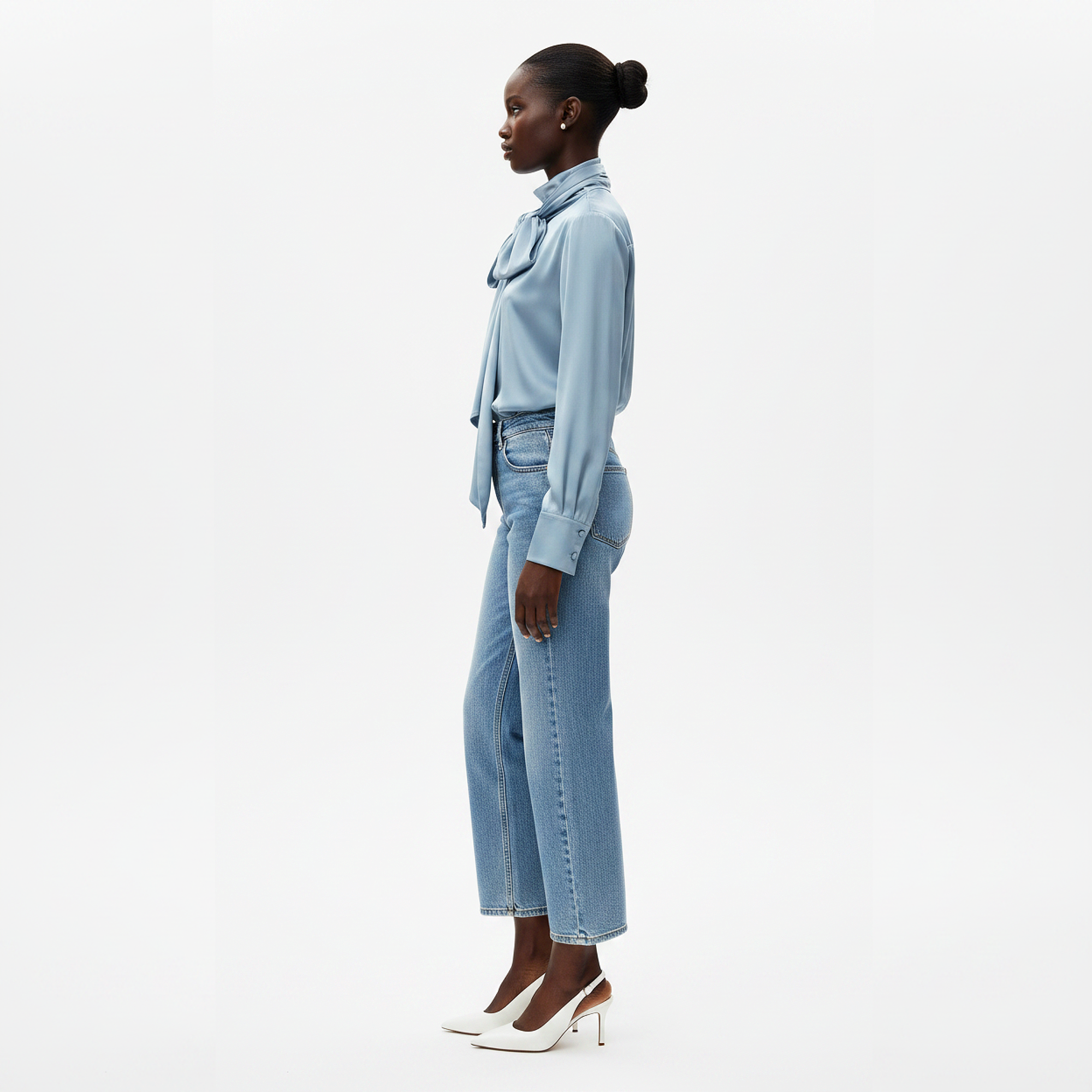 Woman wearing a light blue outfit on a white background