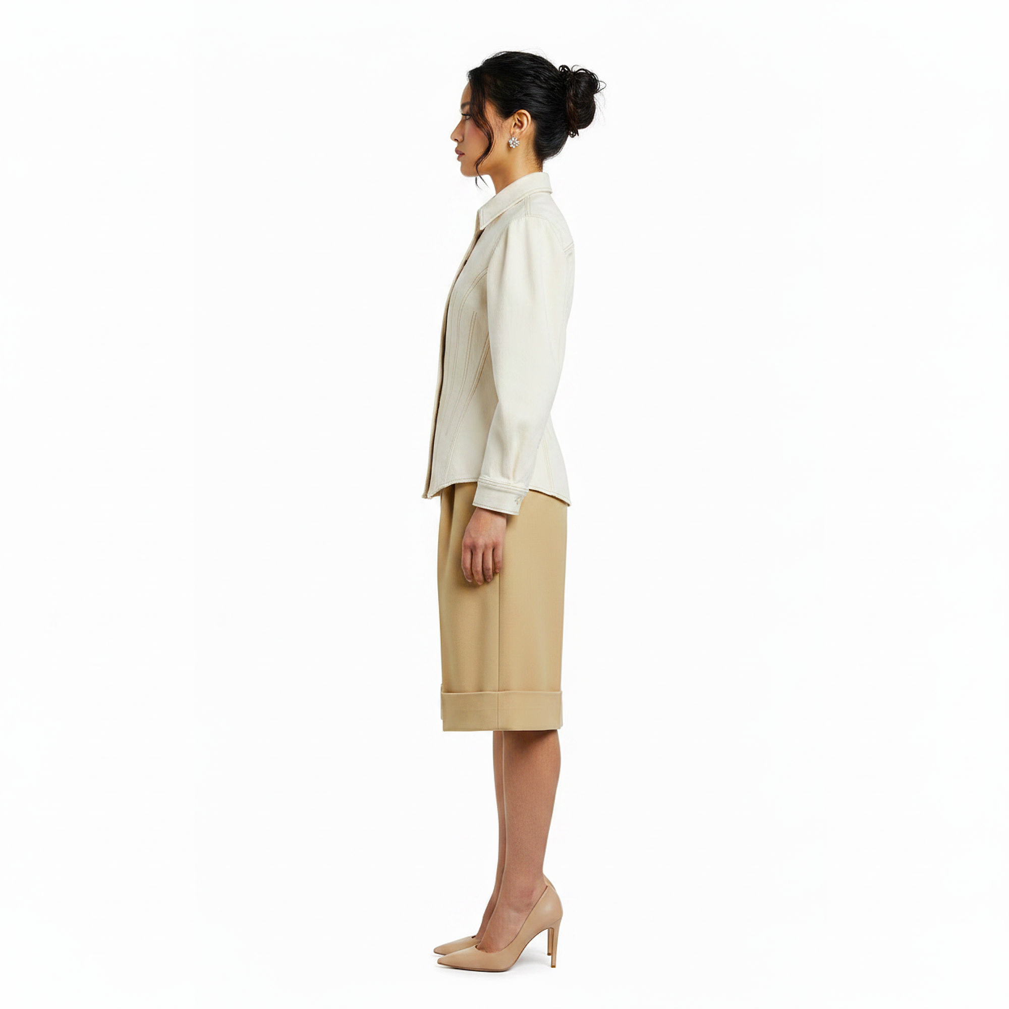 Woman wearing a white blouse and beige skirt on a white background
