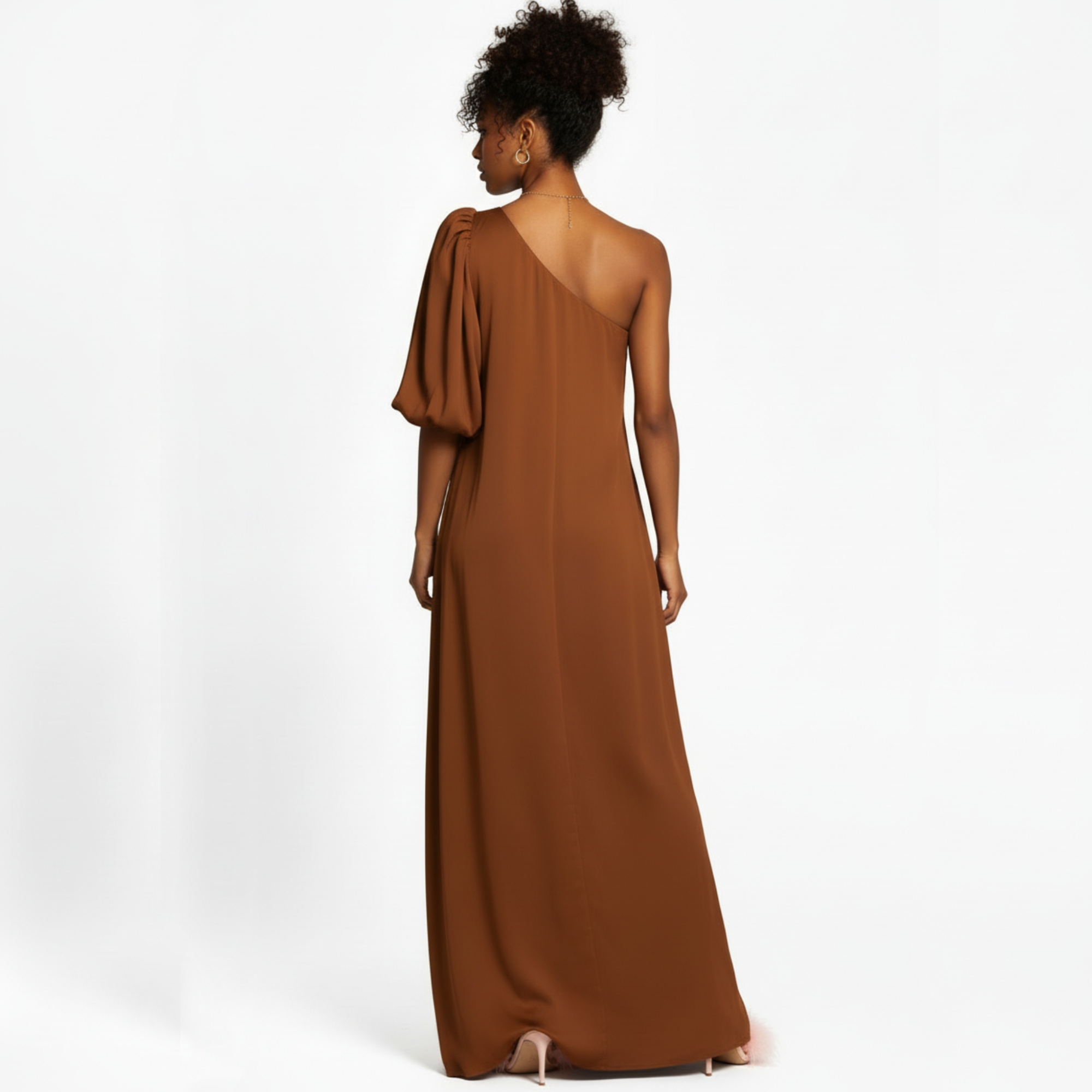 Woman wearing a brown one-shoulder dress on a white background