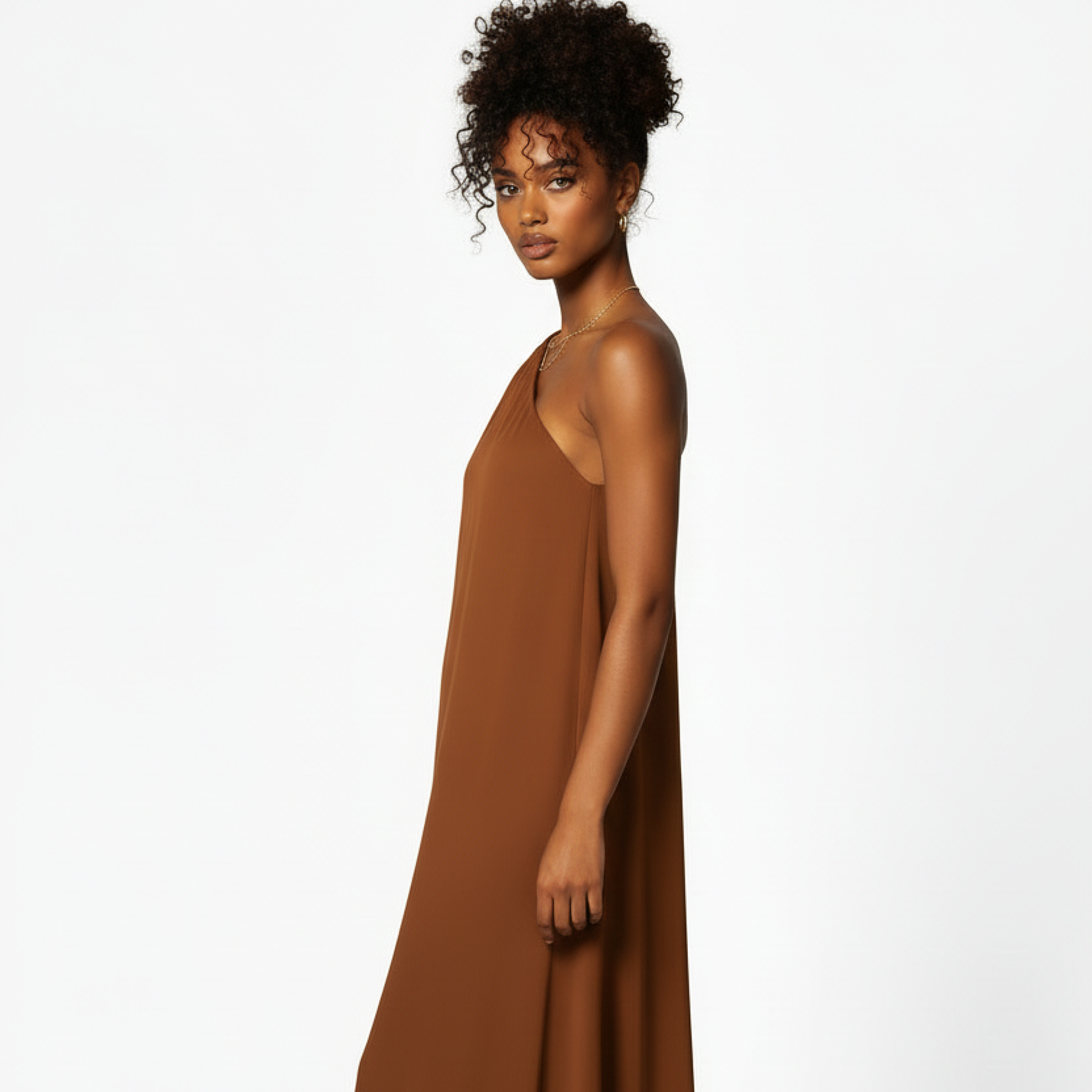 Woman wearing a brown dress against a white background
