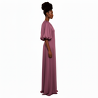 Woman wearing a long, light purple dress on a white background