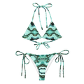 Green and black patterned bikini set on a white background