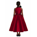 A girl wearing a wine red dress with black bow on a white background