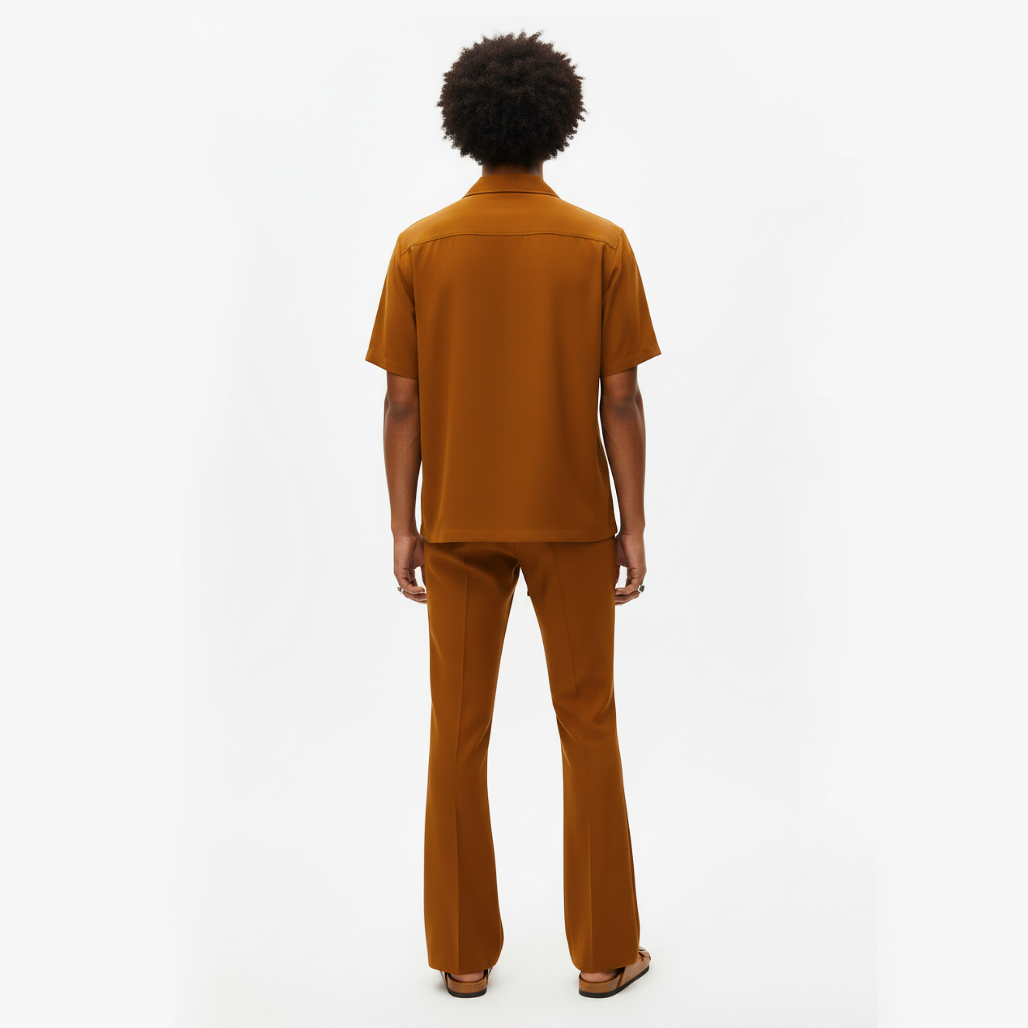 Person wearing a brown outfit on a white background