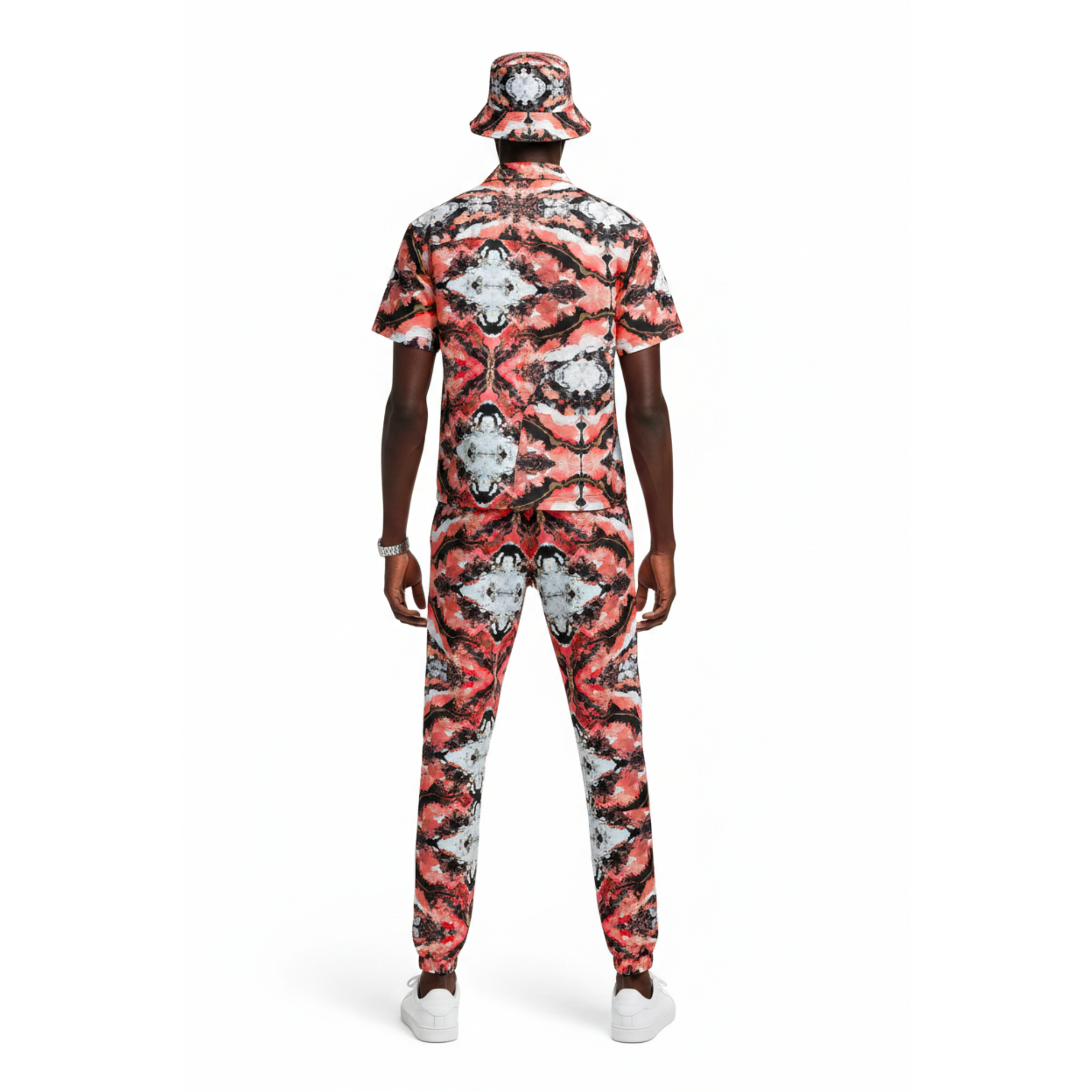 Person wearing a red and black patterned outfit with a matching hat on a white background