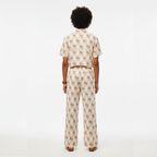 Person wearing a patterned outfit on a white background