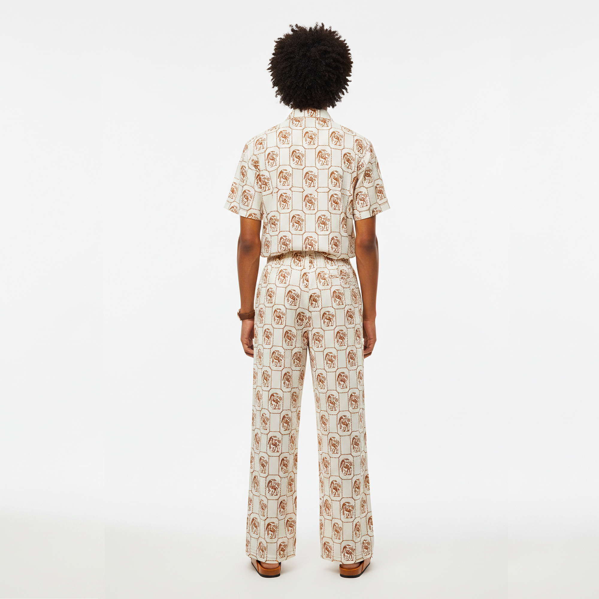 Person wearing a patterned outfit on a white background