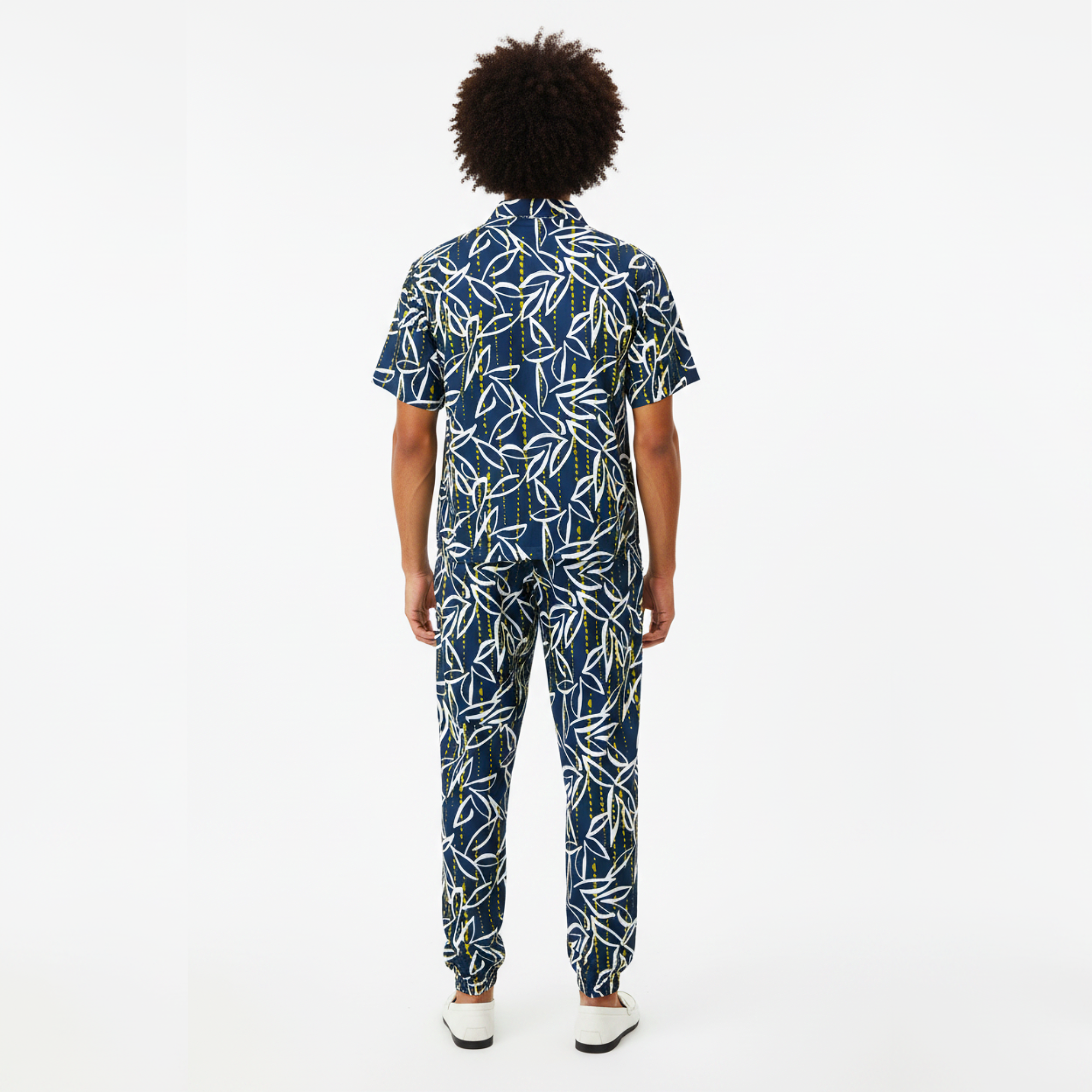 Person wearing a blue and white patterned outfit on a white background