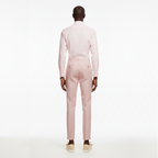Man wearing a light pink suit on a white background