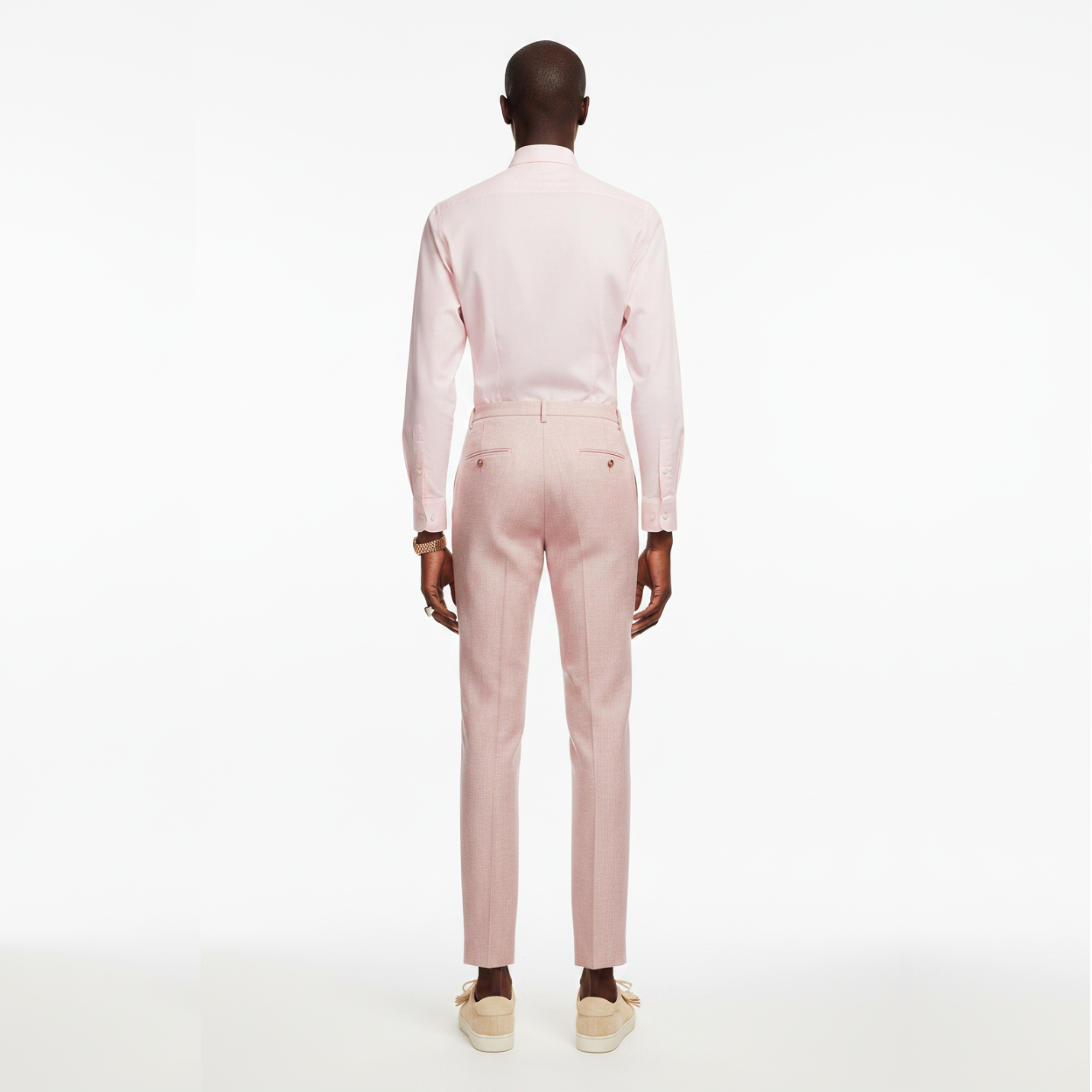 Man wearing a light pink suit on a white background