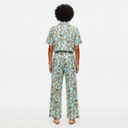 Person wearing a patterned outfit on a white background