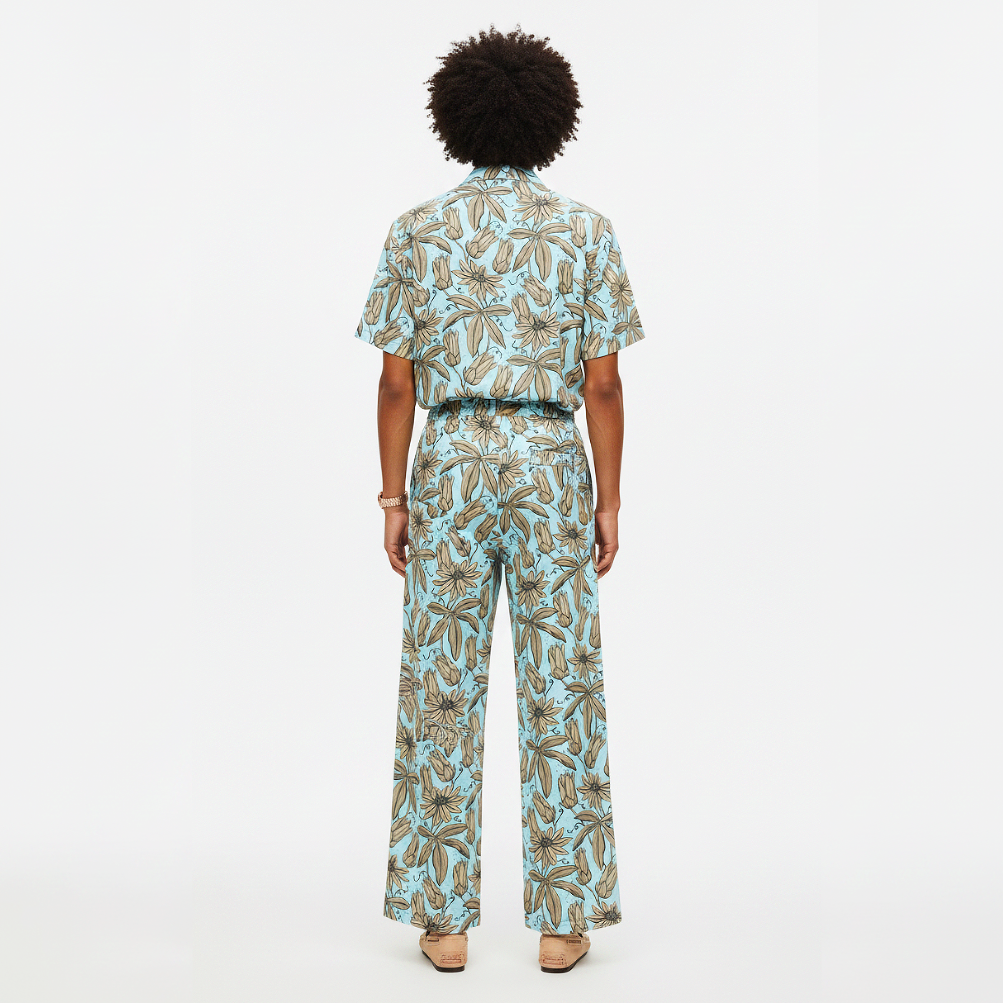 Person wearing a patterned outfit on a white background
