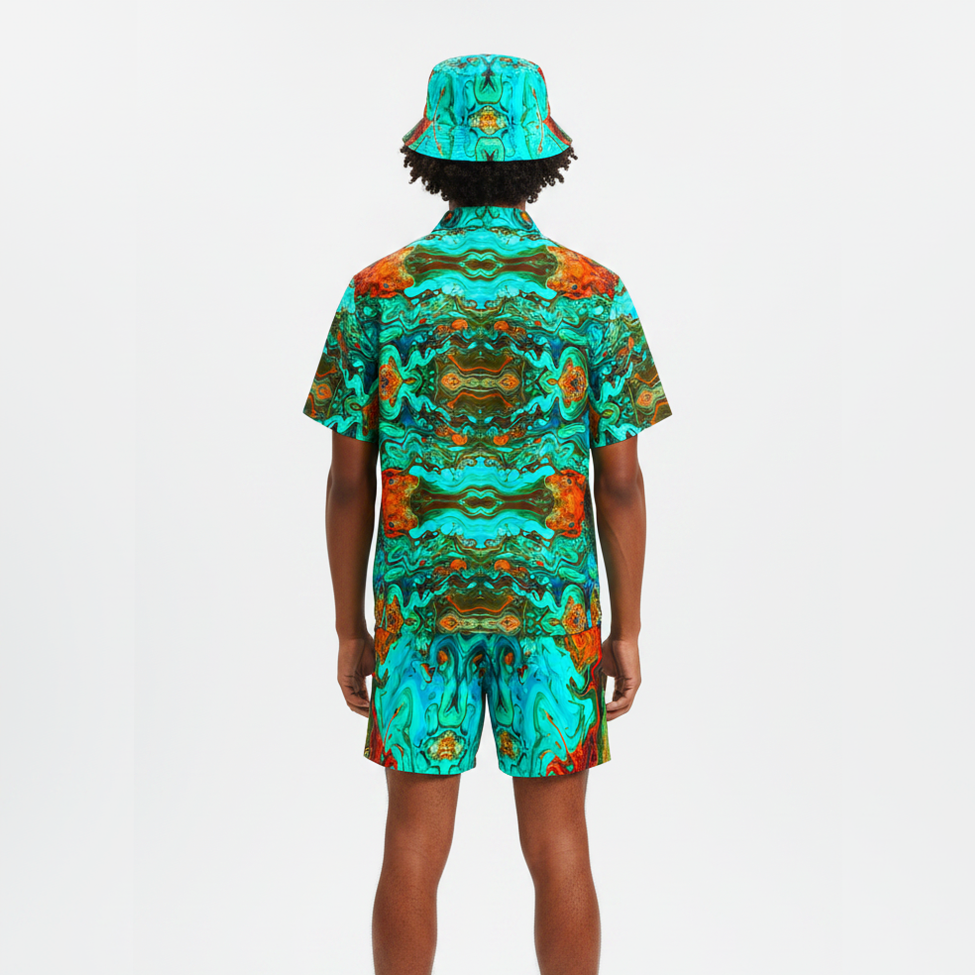 Person wearing a colorful patterned outfit with a matching hat on a white background