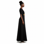 Woman wearing a black dress with a yellow belt on a white background