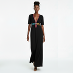 Woman wearing a black dress with colorful design on a white background