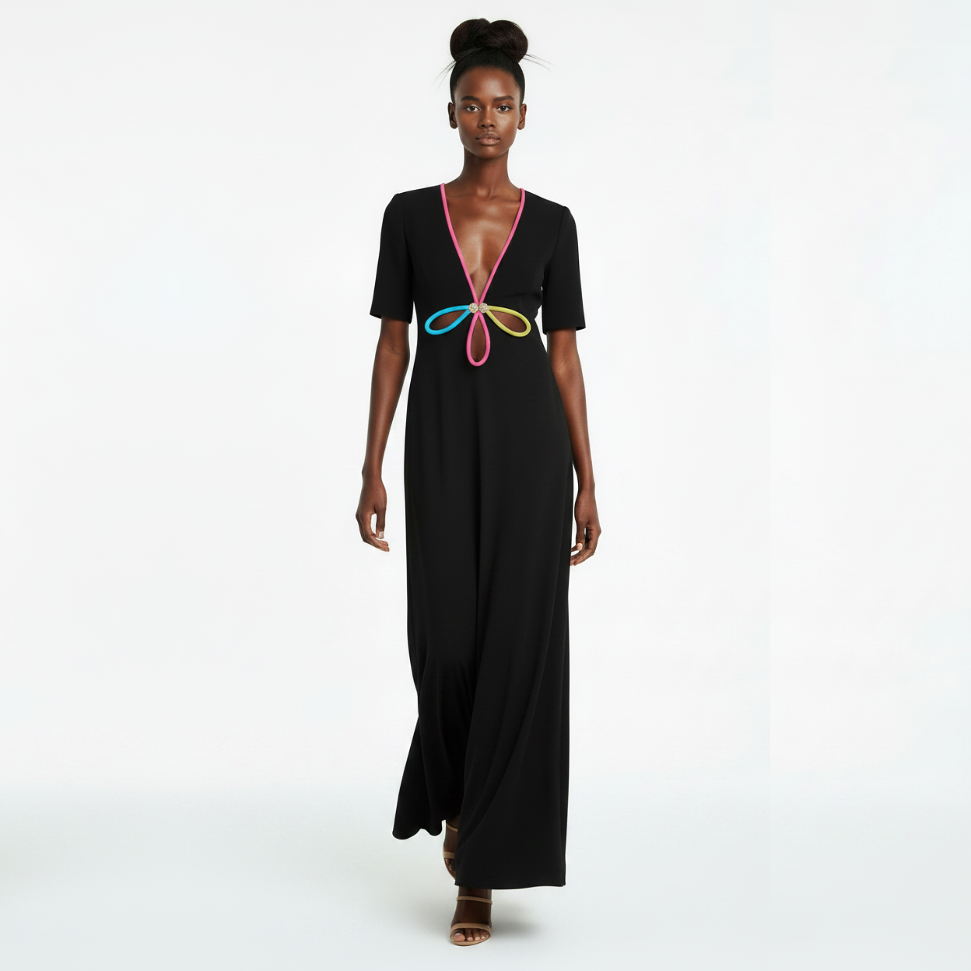 Woman wearing a black dress with colorful design on a white background