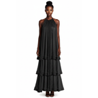 Woman wearing a black tiered dress on a white background