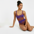 Woman wearing a patterned swimsuit on a white background
