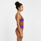 Woman wearing a patterned one-piece swimsuit on a white background